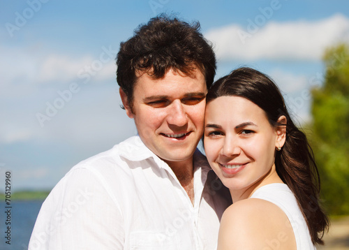 Happy young couple on the river coast