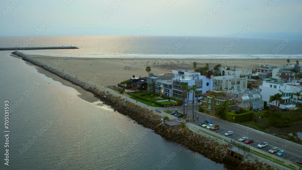 Aerial Panning Scenic Shot Of Residential Buildings In City By Beach, Drone Flying Over Rippled Sea Against Sky - Marina del Rey, California Aerial Panning Scenic Shot Of Residential Buildings In City By Beach, Drone Flying Over Rippled Sea Against Sky - Marina del Rey, California