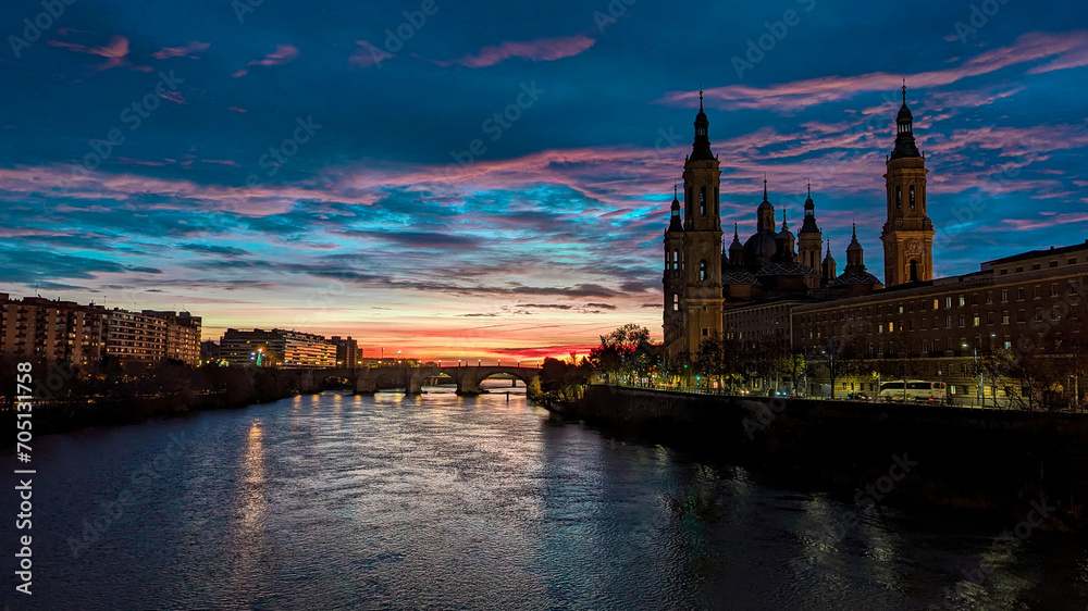 Between Shadows and Lights: The Spectacle of Dawn Illuminating the Basilica del Pilar and the Ebro River
