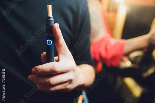 heat-not-burn tobacco product technology. e-cigarette before smoking. photo
