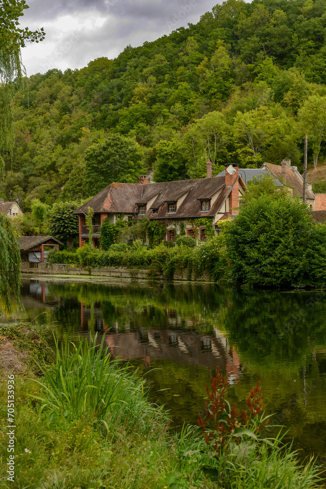 old french house in the greenery near the Iton river in Normandy