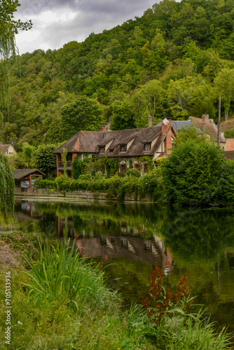 old french house in the greenery near the Iton river in Normandy