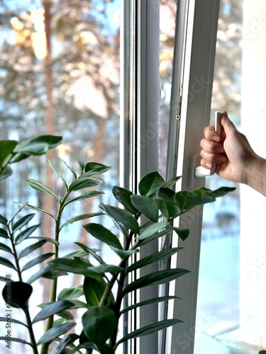 Opening the window for ventilation in winter.