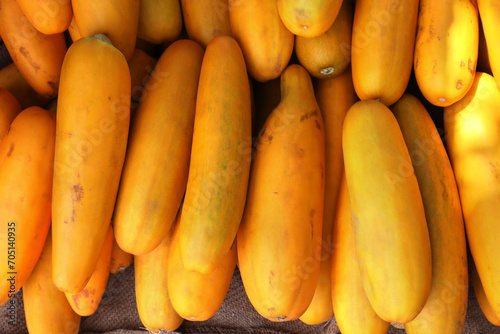 Bunch of fresh yellow cucumbers at market	
