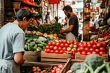 Customers shopping at a local market with fresh tomatoes, cucumbers, and other vegetables on display.