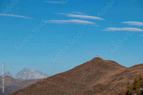 Scenic view of mountain cottage on summit of Helm (Monte Elmo) in Carnic Alps, border Austria Italy. Looking from Monte Gallo, South Tyrol. Distant view of mount Hochgall (Monte Collalto), High Tauern photo