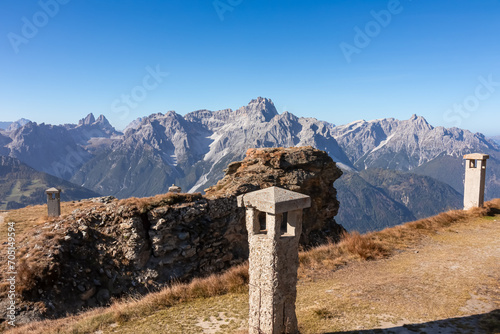 Remains of military bunker of First World War on mount Hornischegg with scenic view of mountain peaks of untamed Sexten Dolomites, South Tyrol, border Austria Italy, Europe. Wanderlust concept in Alps photo