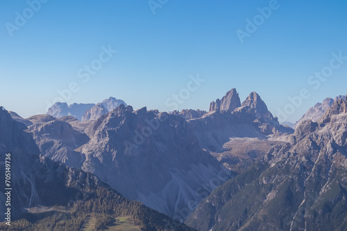 Scenic view of majestic mountain peaks of Tre Cime (Drei Zinnen) in untamed Sexten Dolomites, South Tyrol, Italy, Europe. Hiking concept Italian Alps. Blue clear sky. Looking from summit Hornischegg