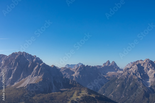 Scenic view of majestic mountain peaks of Tre Cime  Drei Zinnen  in untamed Sexten Dolomites  South Tyrol  Italy  Europe. Hiking concept Italian Alps. Blue clear sky. Looking from summit Hornischegg