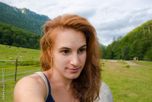 Young woman near a sheep pasture in Slovakia
