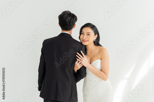 Love and commitment reflected in the smiles of an Asian couple as they present their wedding ring. Joyful Asian bride and groom share a moment of bliss, showcasing a sparkling wedding ring.