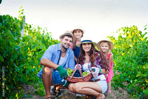 Happy family on grape farm in summer time