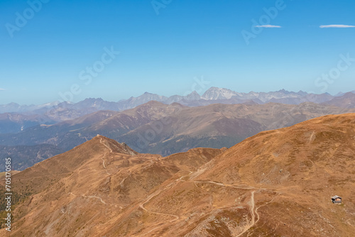 Scenic view of mountain cottage on summit of Helm (Monte Elmo) in Carnic Alps, border Austria Italy. Looking from Hornischegg, South Tyrol. Distant view of mount Hochgall (Monte Collalto), High Tauern photo