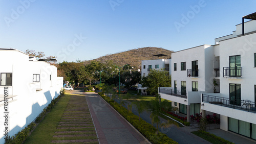 White house surrounding by green areas in front of the mountain in the city of eternal spring, Morelos, Mexico.