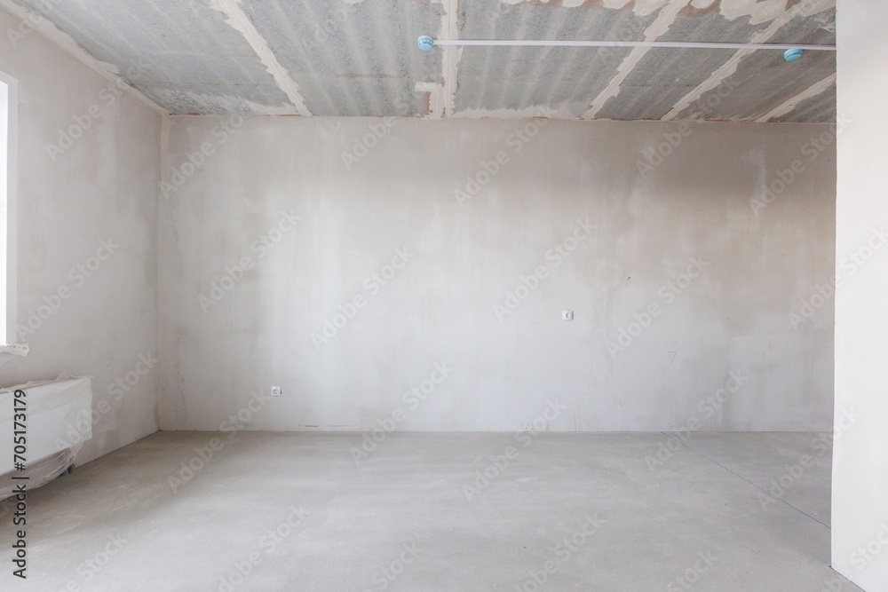 Fototapeta premium interior of the apartment without decoration in gray colors. rough finish