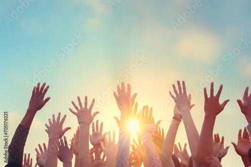 People of different ethnicities raising their hands in the air