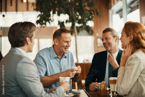 Happy diverse business people laughing in cafe photo