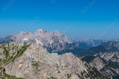 Scenic view from Mangart Saddle (Mangartsko sedlo) on Jof Fuart and Jof di Montasio in untamed Julian Alps, Friuli Venezia Giulia, Italy, Europe. Hiking wanderlust in alpine wilderness in Italian Alps photo