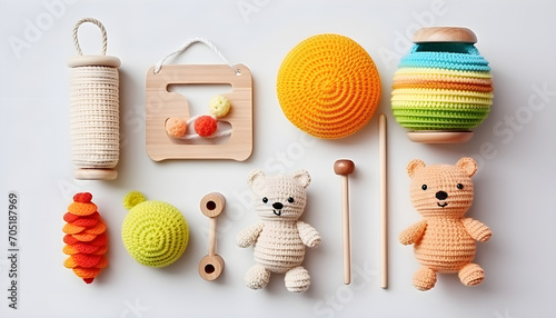 colorful wooden and knitting eco toys for baby activity, motor and sensory development on white table top view photo