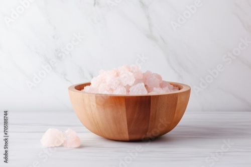 pink himalayan salt in marble small bamboo wooden bowl at minimal kitchen with marble wall background