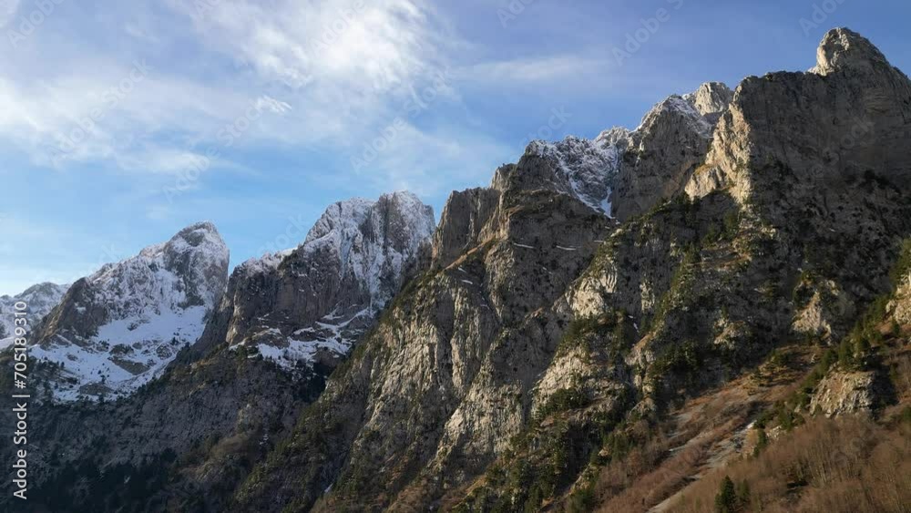 The drone flies along a mountain range with epic snowy peaks The drone flies along a mountain range with epic snowy peaks