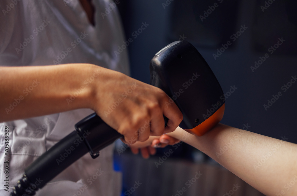 Fototapeta premium Young woman receiving photo epilation while visiting beauty center on salon