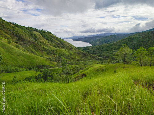 Beautiful Green Grass Hill in West Seram Regency, Maluku, Indonesia photo