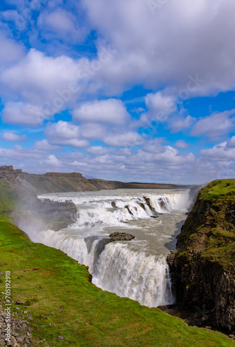 Gulfoss is a big waterfall in Iceland and major attraction and natural wonder on the Golden Circle tourist circuit in the south of the Island. Melting water splashing into a lava canyon on sunny day.