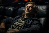 mature man sleeping in the cinema