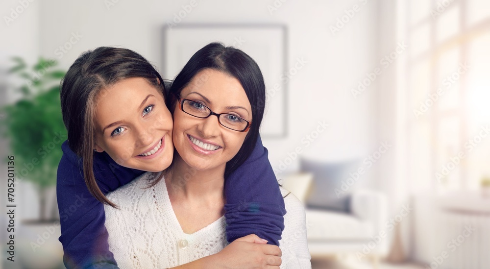 Young loving happy mother hugging teenage daughter Young loving happy mother hugging teenage daughter