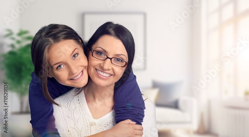 Young loving happy mother hugging teenage daughter