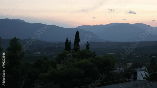 pan across landscape with mountains and small european village in agrolis greece (night time, dusk, blue hour, sunset footage) mykines photo