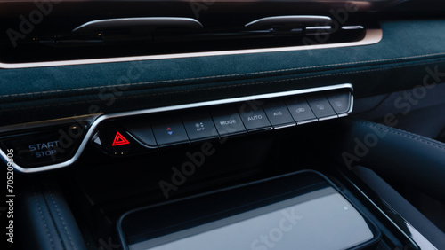 Emergency stop button on the car dashboard with dark green Alcantara interior trim © AvokadoStudio