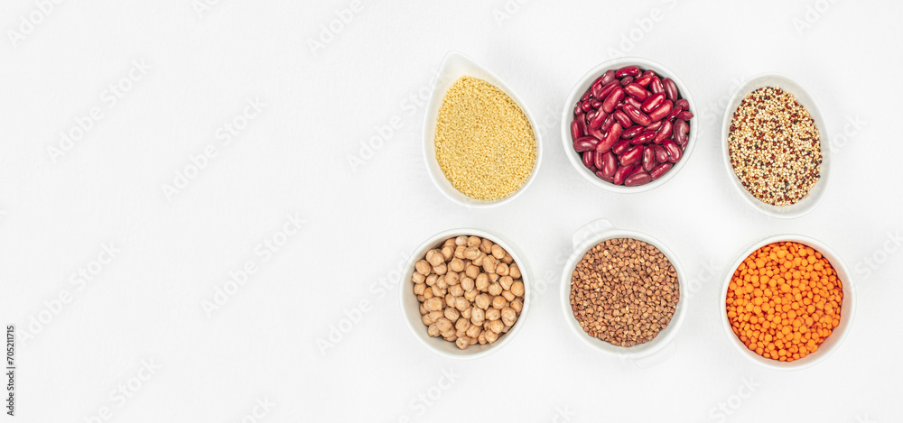 Bowls with different gluten free grains on a white background, Healthy food concept. Long banner format. top view. copy space for text