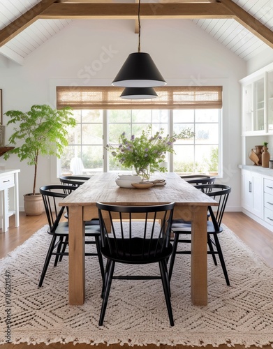 Black spindle back chairs with a wood table and white walls