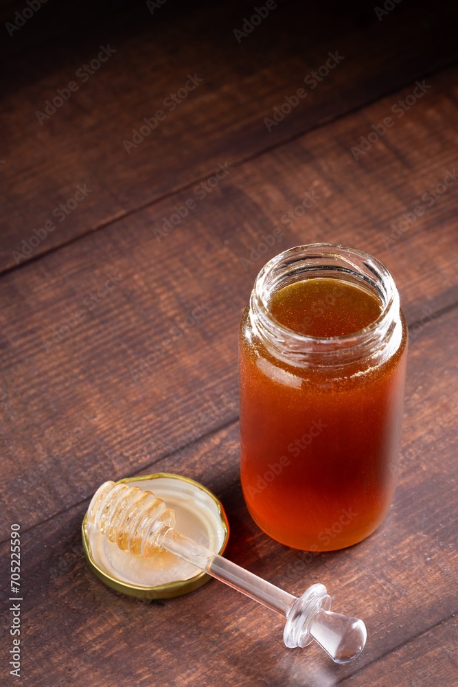 Glass jar of honey. Fresh honey in the jar. Glass jar of honey. Fresh honey in the jar.