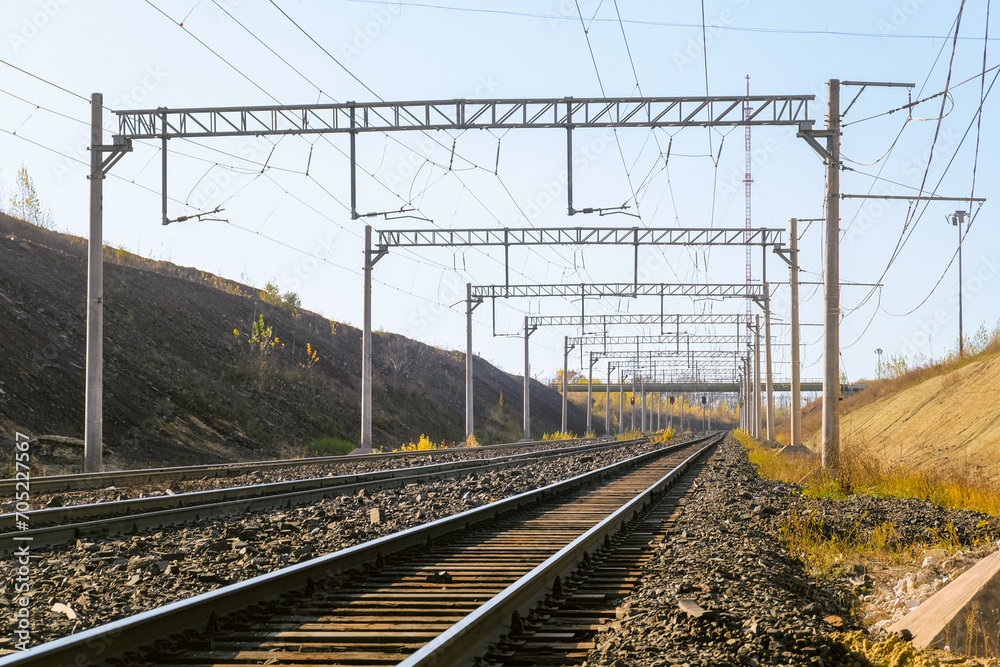 Electrified multi-track railway. Railway contact network on steel poles and trusses.