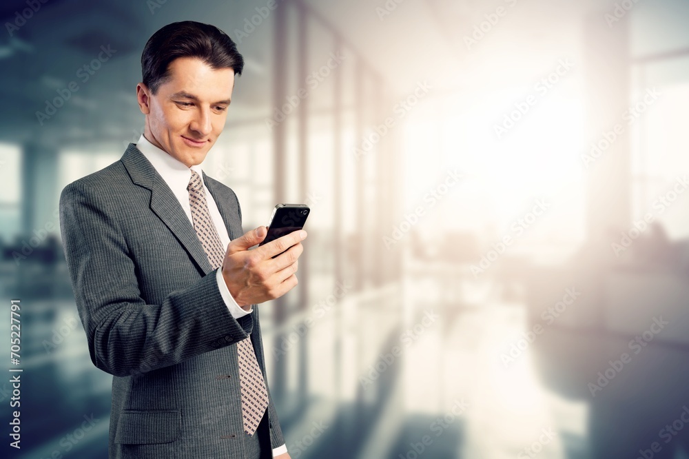 Smiling handsome business man using phone Smiling handsome business man using phone