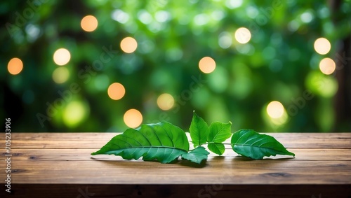 green leaves on wooden background blurred lights 