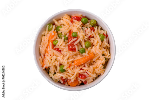 Delicious boiled rice with vegetables peppers, green peas, salt, spices and herbs