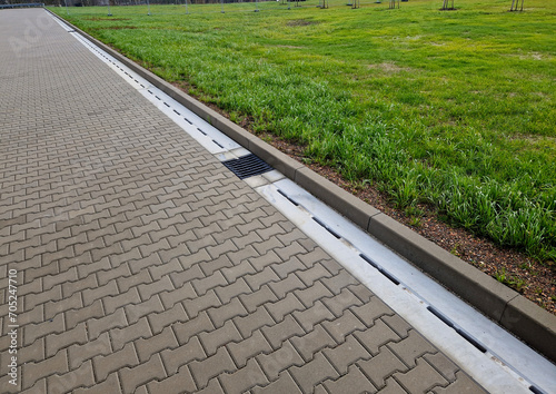 Obraz na plátně Slotted pipes drain rainwater and oil substances, drips from paved surfaces