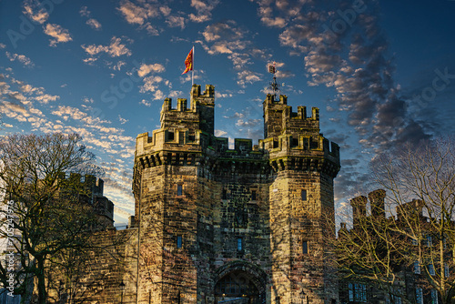 Obraz na płótnie Historic stone castle with towers against a blue sky with scattered clouds at sunset in Lancaster