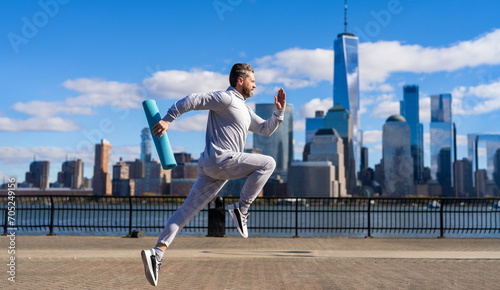 Sportsman jogger running or jogging. Man in sports suit training jogging. Running man in Manhattan. Morning sport workout jogger run in New York. The jogger run at sport training