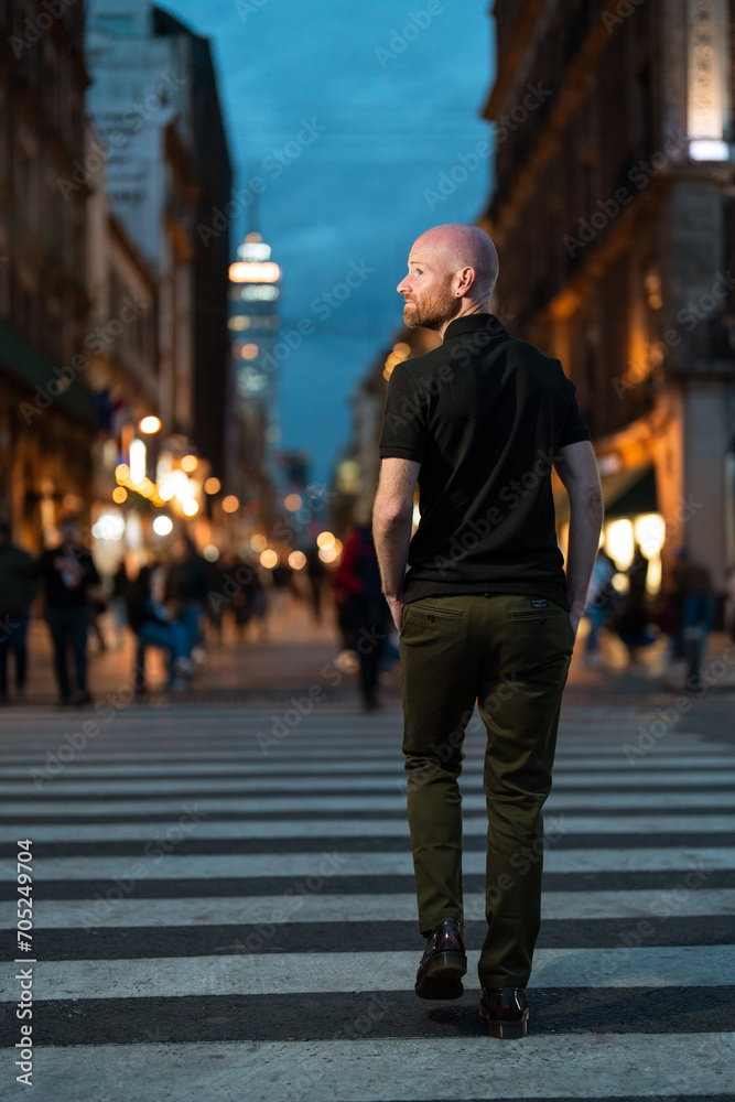 Young white man on vacation exploring the city streets