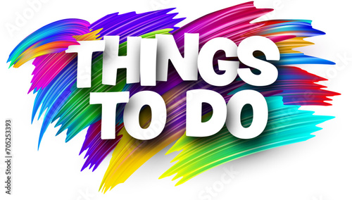 Things to do paper word sign with colorful spectrum paint brush strokes over white.