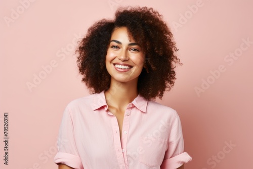 Portrait of a smiling african american woman on pink background