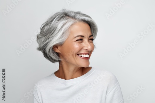 Portrait of happy senior asian woman with grey hair and white smile