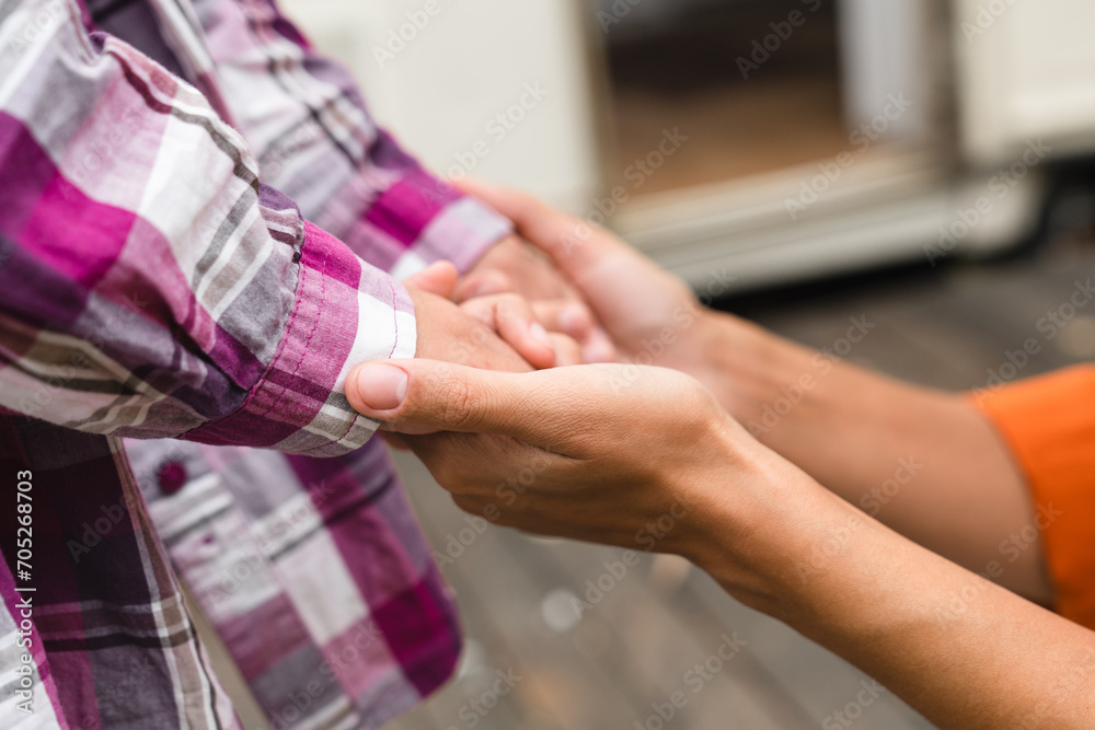 Cropped image of mother`s and daughter`s hands holding together, playing, supporting, helping while traveling by trailer caravanning by motor home camper on road trip
