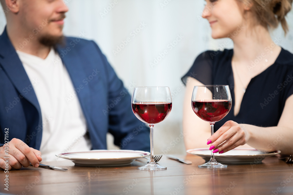 A married couple celebrating their anniversary with a glass of wine. A married couple celebrating their anniversary with a glass of wine.