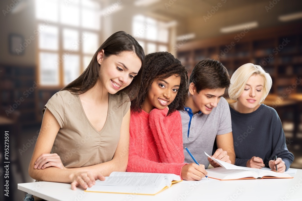Confident group of college students sitting at classroom Confident group of college students sitting at classroom